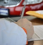 man writing on paper 