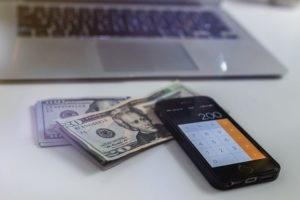 money phone and laptop 